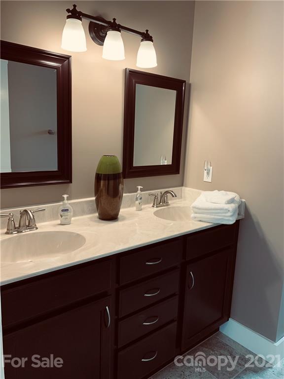 605 Souther Road Fletcher, NC 28732 - Photo 23 of 31 a bathroom with a double vanity sink and a mirror