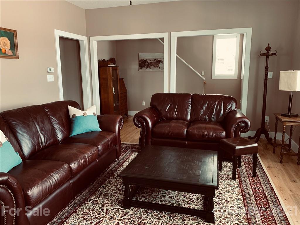 605 Souther Road Fletcher, NC 28732 - Photo 8 of 31 a living room with a couch and a dresser