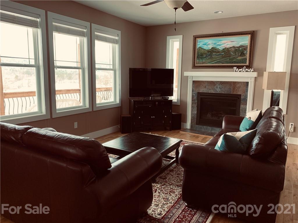 605 Souther Road Fletcher, NC 28732 - Photo 9 of 31 a living room with furniture a flat screen tv and a fireplace
