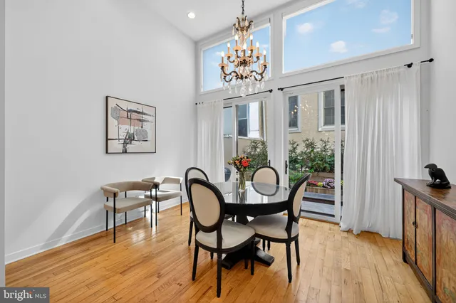 a view of a dining room with furniture a chandelier and wooden floor