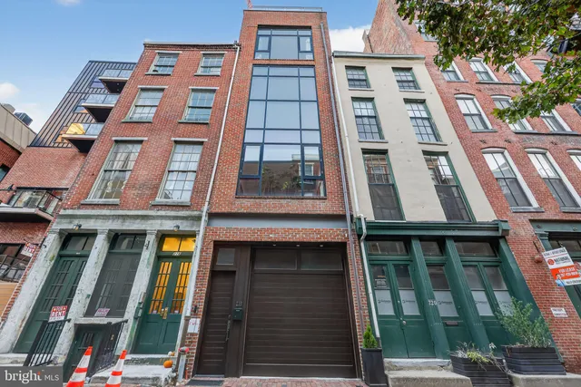 a view of a hallway with wooden floor and stairs