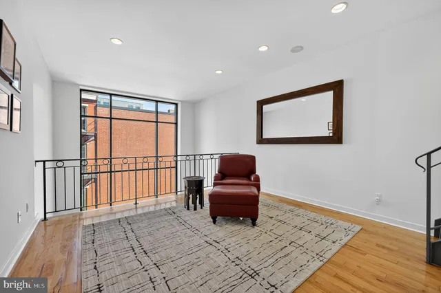 a bedroom with a bed and a window with rug