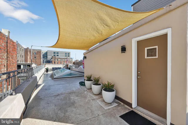 a view of a hallway with wooden floor and entryway