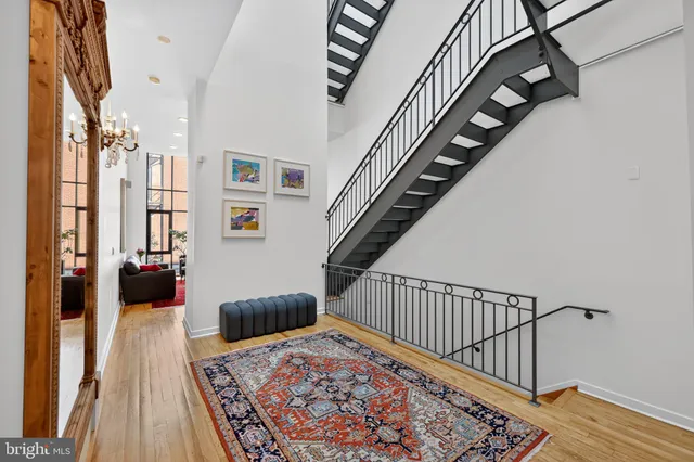 a living room with furniture rug and a large window