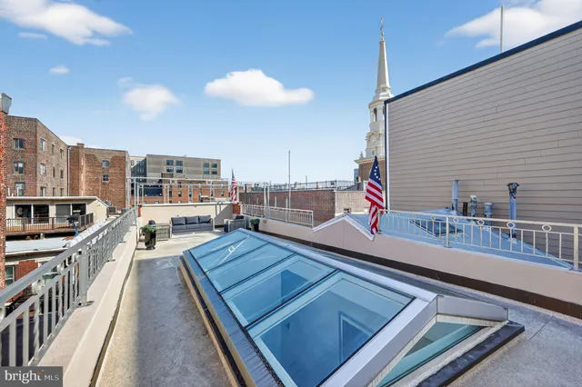 a view of staircase with lots of frames on wall and a window