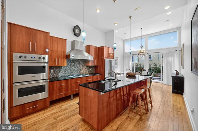 a kitchen with stainless steel appliances granite countertop a refrigerator and a sink