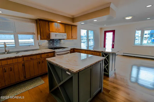 a kitchen with a stove a sink and a refrigerator