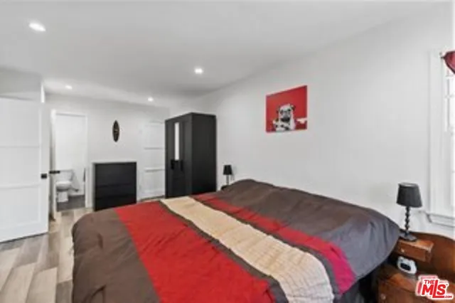 a bedroom with a large bed and a fireplace