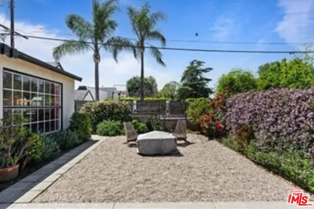 a couple of potted plants in front of a house