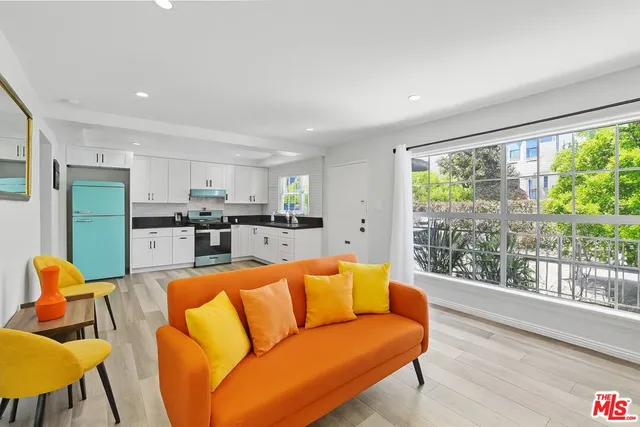 a view of a living room kitchen and a wooden floor