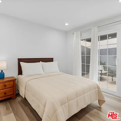 a large bed sitting in a bedroom next to a window