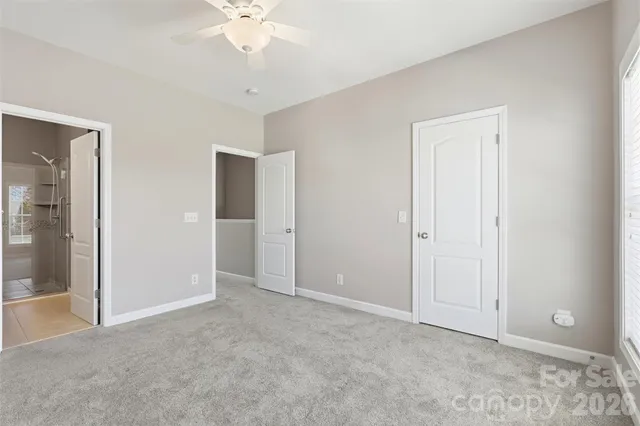 an empty room with fan and entrance