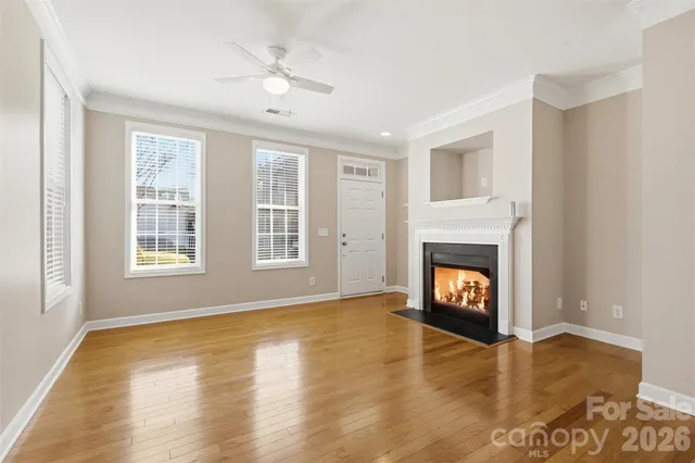 a view of an empty room with a fireplace and a window