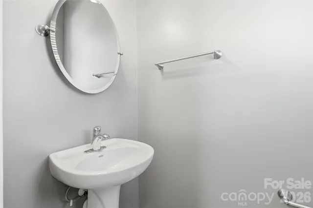 a bathroom with a sink a mirror and a toilet