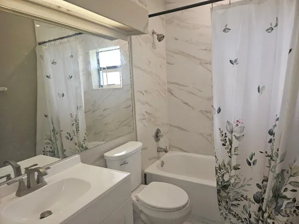 a bathroom with a double vanity sink and mirror