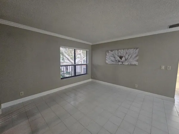 an empty room with closet and a bathroom