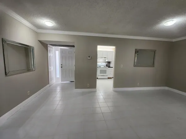 a kitchen with white cabinets and appliances