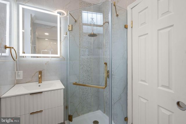 a white bath tub sitting in a bathroom and shower