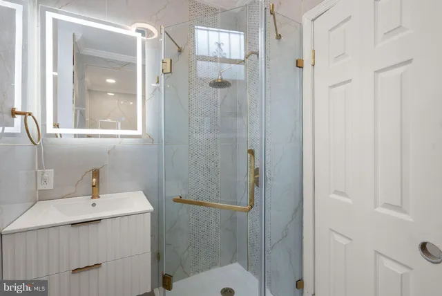a white bath tub sitting in a bathroom and shower