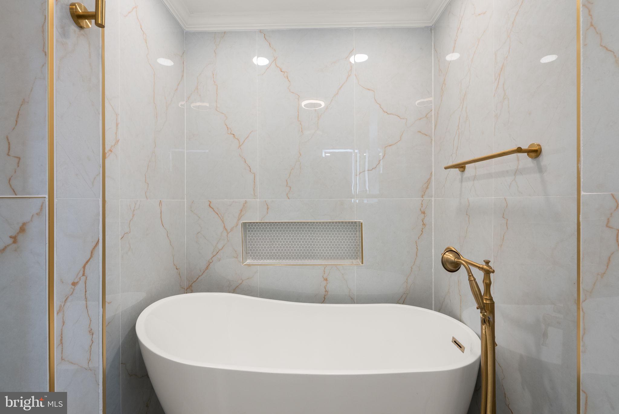 74 O Street Northwest Washington, DC 20001 - Photo 19 of 24 a white bath tub sitting in a bathroom and shower