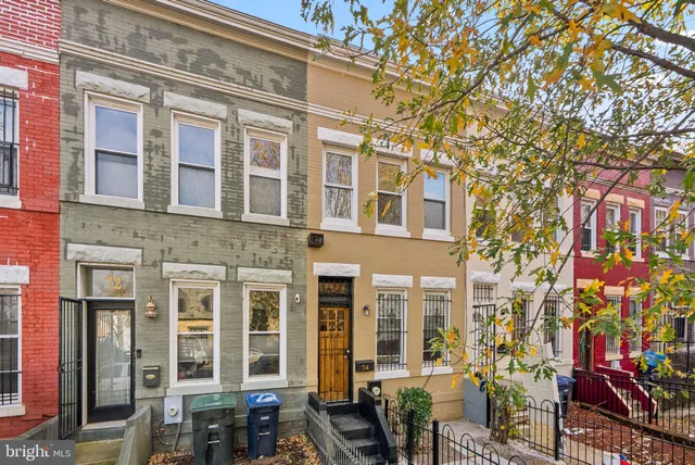 a front view of a multi story building with yard