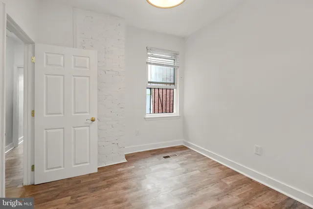 a couple of cars parked in front of brick building