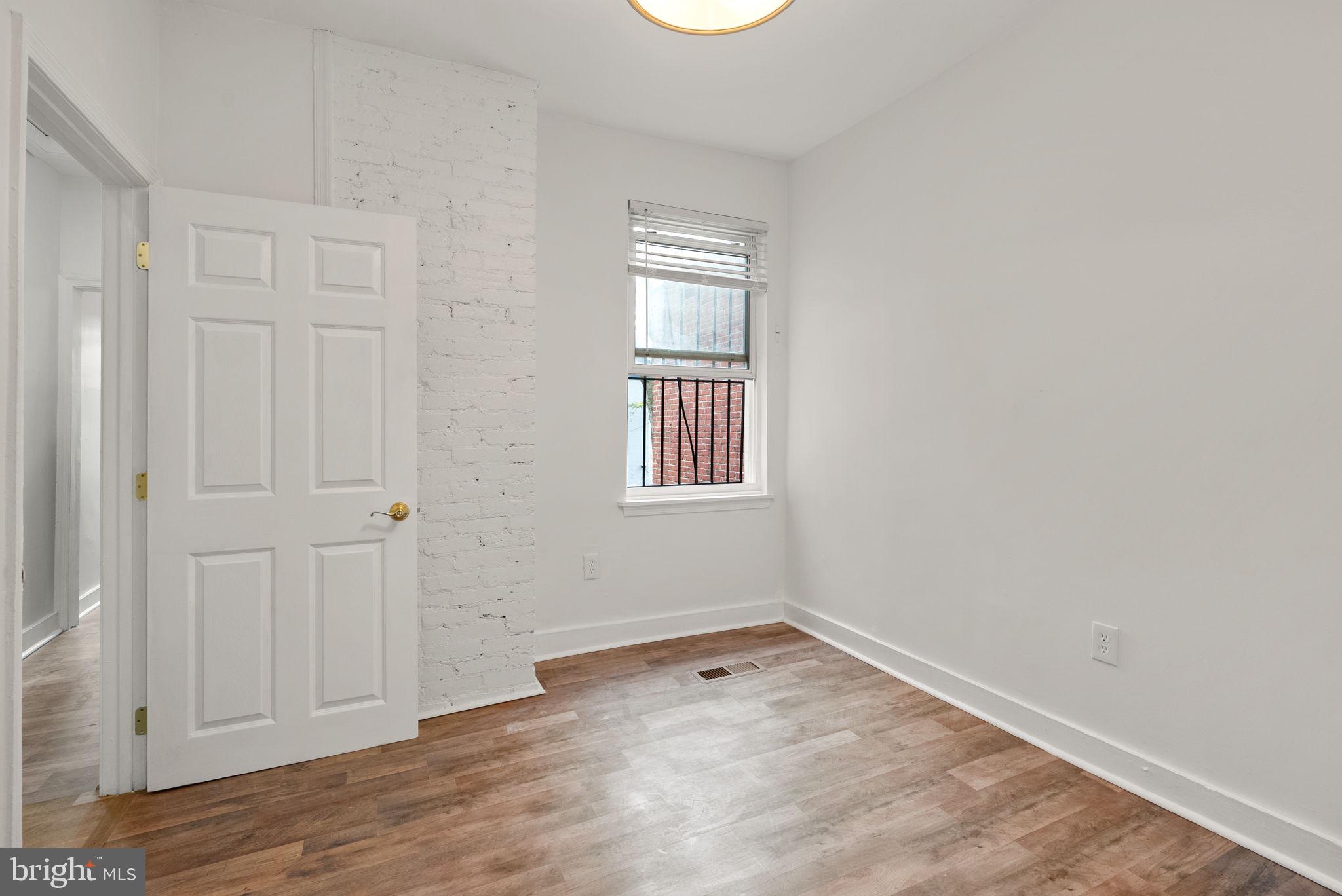 74 O Street Northwest Washington, DC 20001 - Photo 21 of 24 an empty room with wooden floor and windows