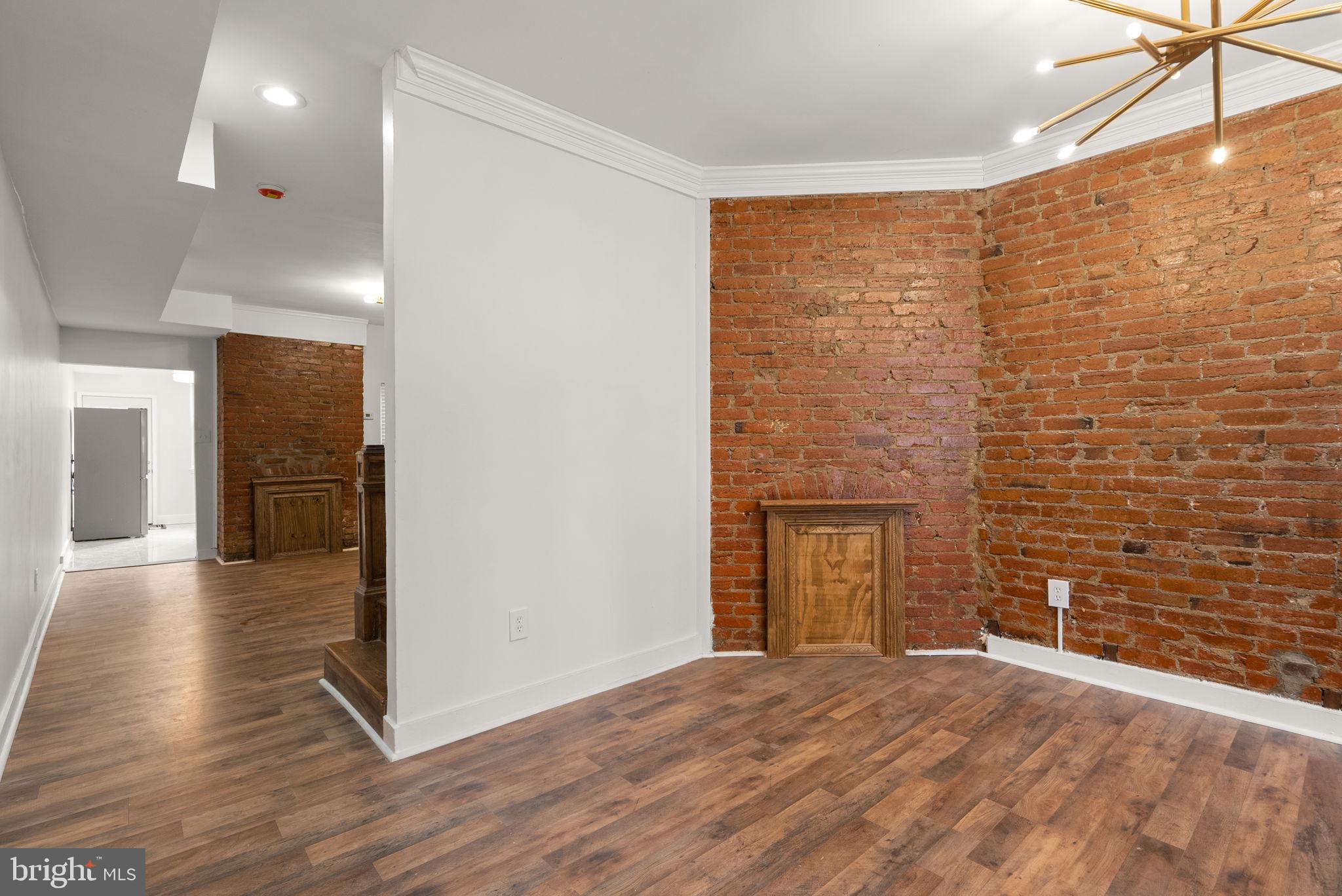 74 O Street Northwest Washington, DC 20001 - Photo 5 of 24 a view of an empty room with wooden floor and a window