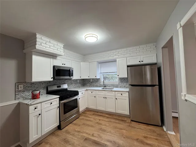 a kitchen with a sink stove and refrigerator