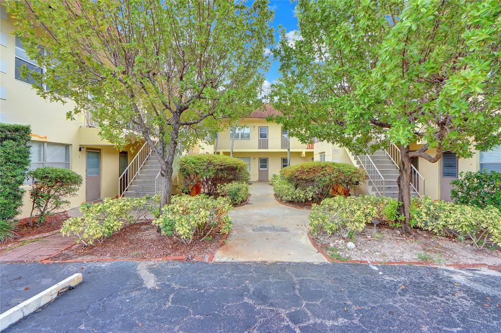 260 Northwest 19th Street, Unit 1 Boca Raton, FL 33432 - Photo 14 of 14 a front view of a house with a yard and a garage