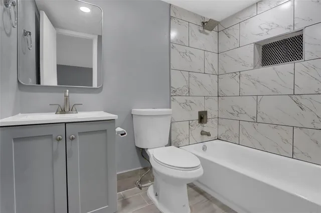 a bathroom with a toilet sink and bathtub