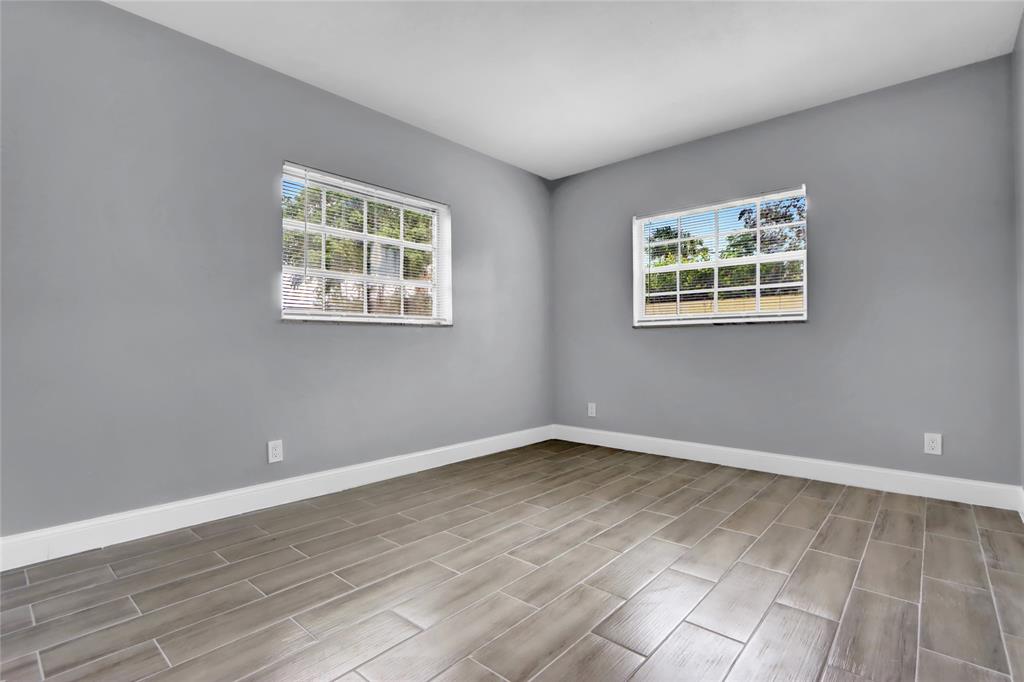 260 Northwest 19th Street, Unit 1 Boca Raton, FL 33432 - Photo 10 of 14 a view of an empty room with wooden floor and a window