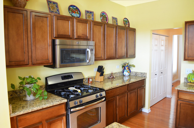1219 Mariemont Road Sugar Grove, IL 60554 - Photo 8 of 25 a kitchen with stainless steel appliances granite countertop a stove a sink and a microwave