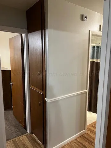 a bed sitting in a bedroom next to a lamp