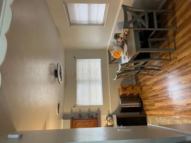 a kitchen with stainless steel appliances kitchen island granite countertop a sink a stove and a refrigerator