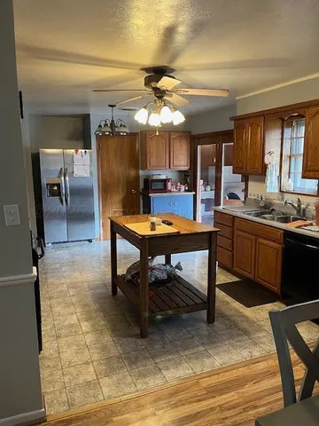 a kitchen with a stove a sink and cabinets