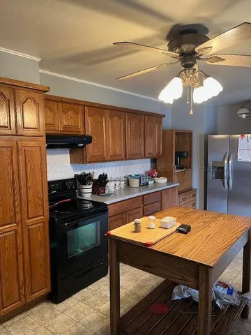 a kitchen with stainless steel appliances granite countertop a stove top oven a sink dishwasher and cabinets with wooden floor