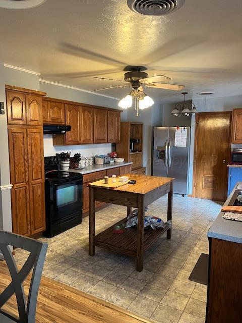 622 North 14th Street Memphis, TX 79245 - Photo 27 of 29 a kitchen with stainless steel appliances kitchen island granite countertop a sink a stove and a refrigerator