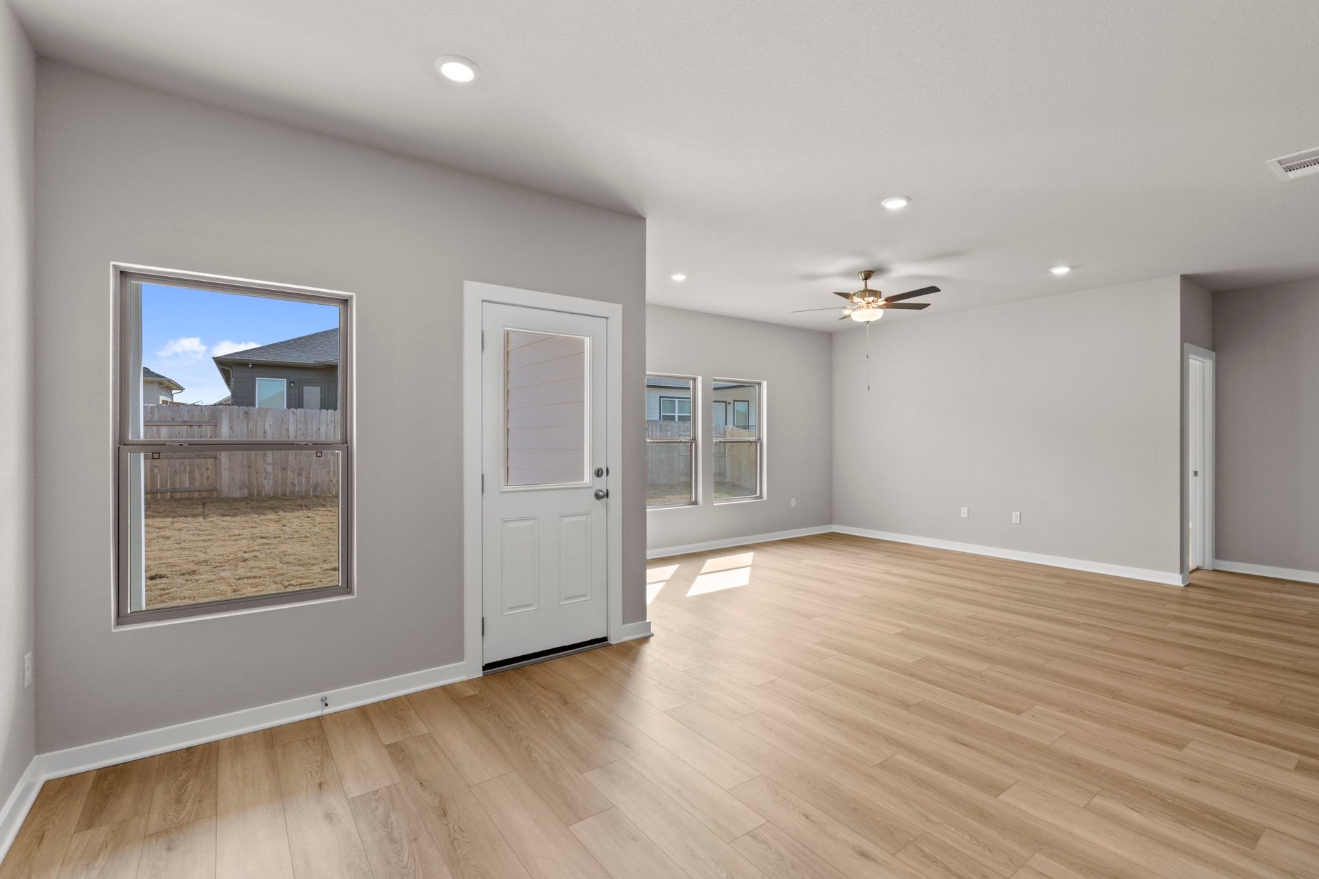 13621 Gray Landing Drive Elgin, TX 78621 - Photo 12 of 36 an empty room with wooden floor and windows