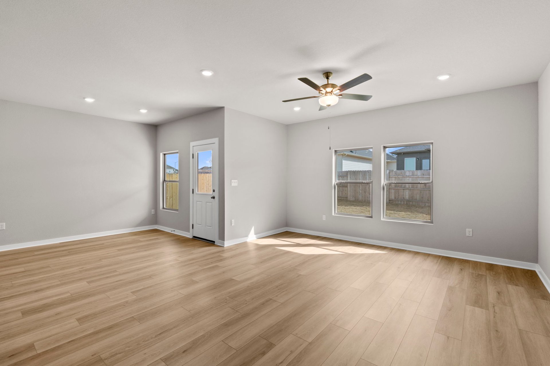 13621 Gray Landing Drive Elgin, TX 78621 - Photo 14 of 36 a view of an empty room with a window and wooden floor