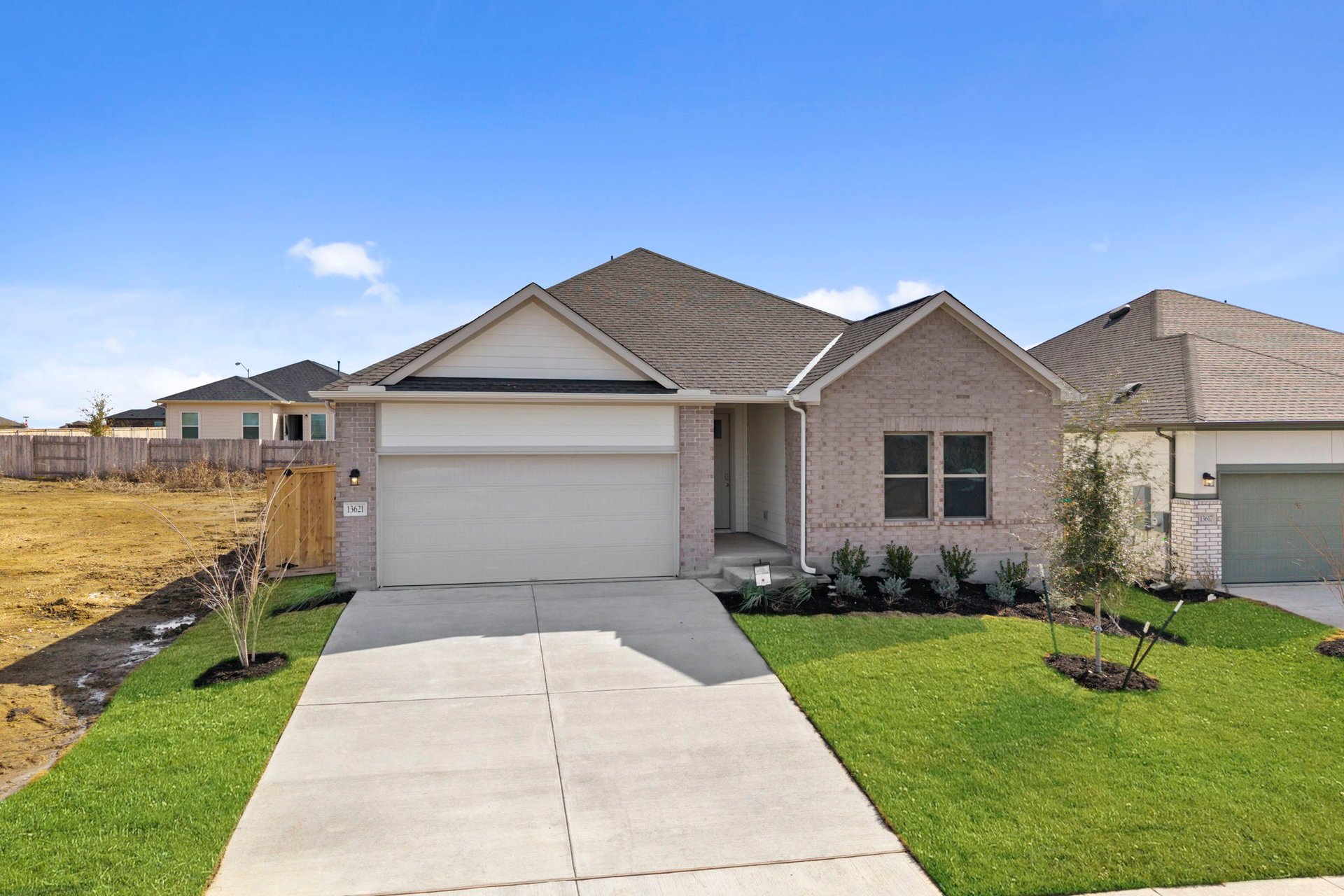 13621 Gray Landing Drive Elgin, TX 78621 - Photo 2 of 36 a front view of a house with a garden