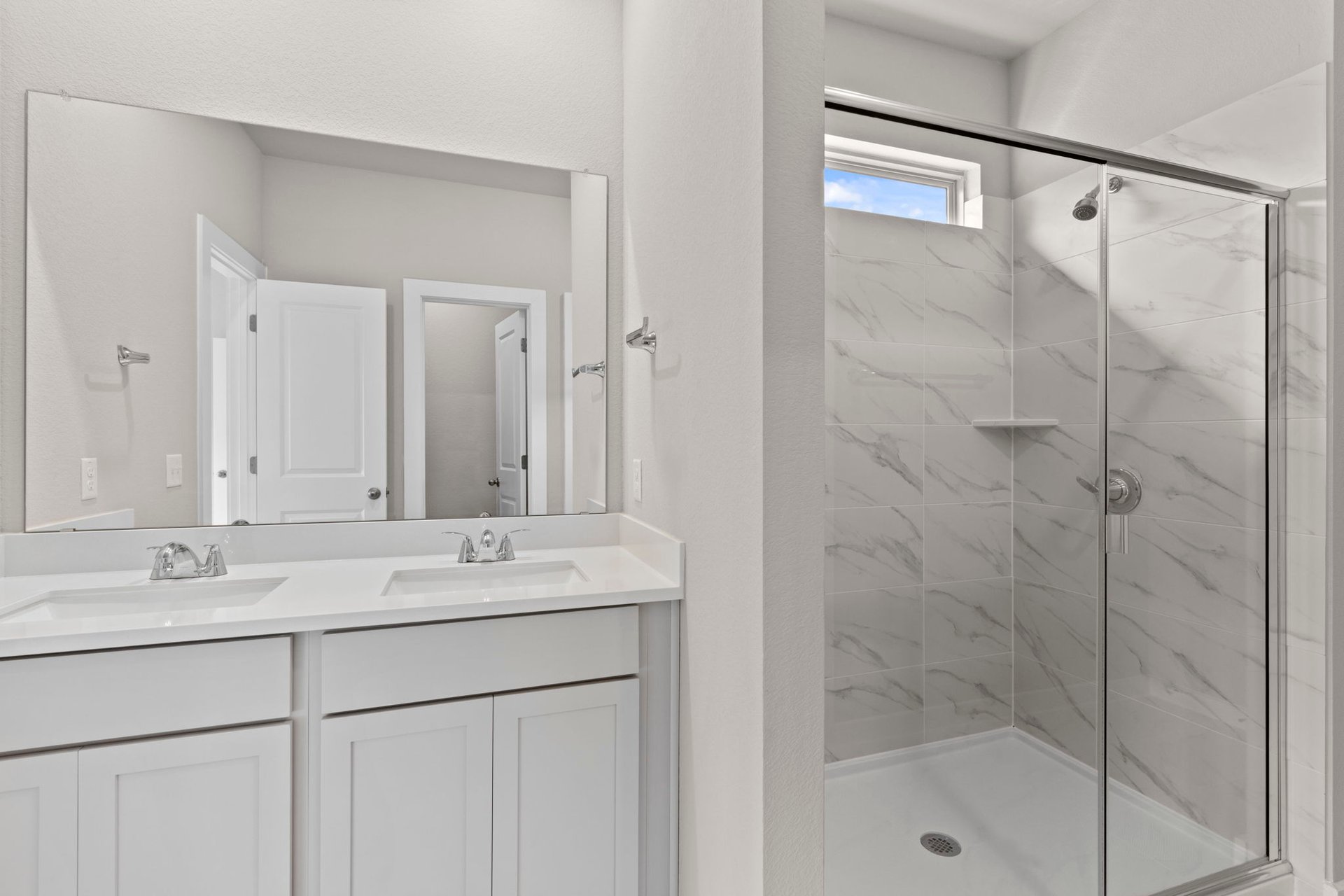 13621 Gray Landing Drive Elgin, TX 78621 - Photo 21 of 36 a bathroom with a shower sink vanity and mirror