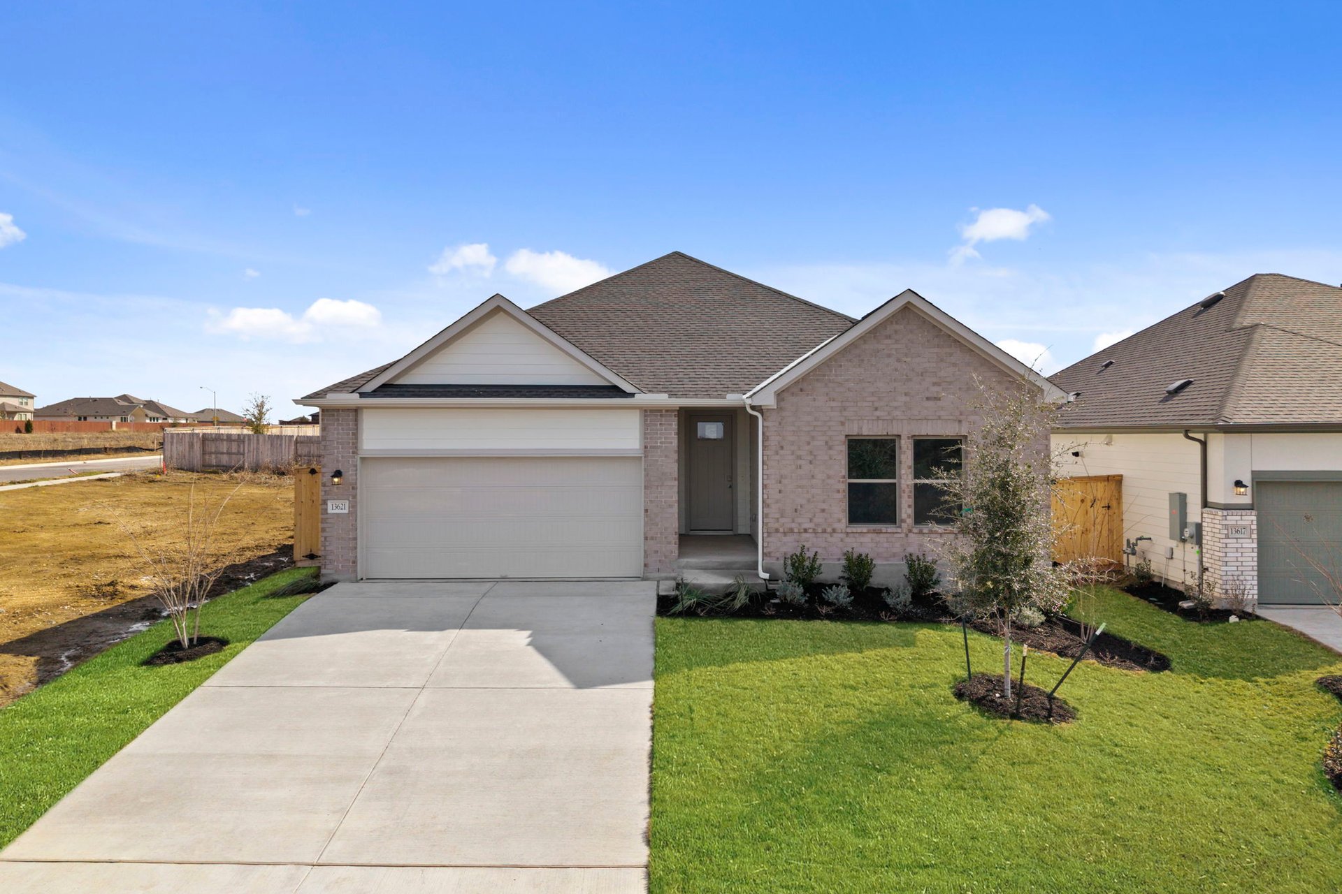13621 Gray Landing Drive Elgin, TX 78621 - Photo 3 of 36 a front view of a house with garden