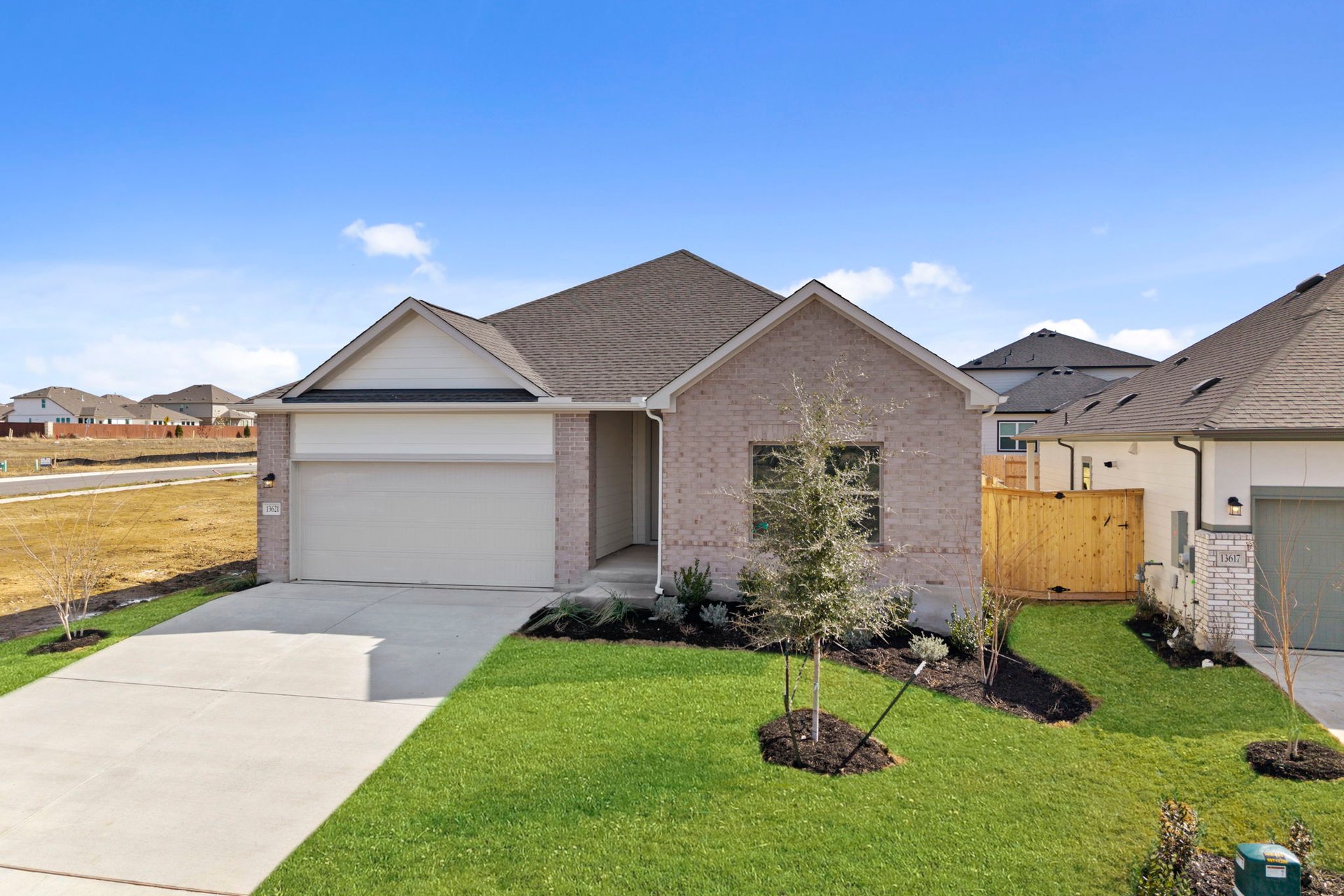 13621 Gray Landing Drive Elgin, TX 78621 - Photo 4 of 36 a front view of a house with garden