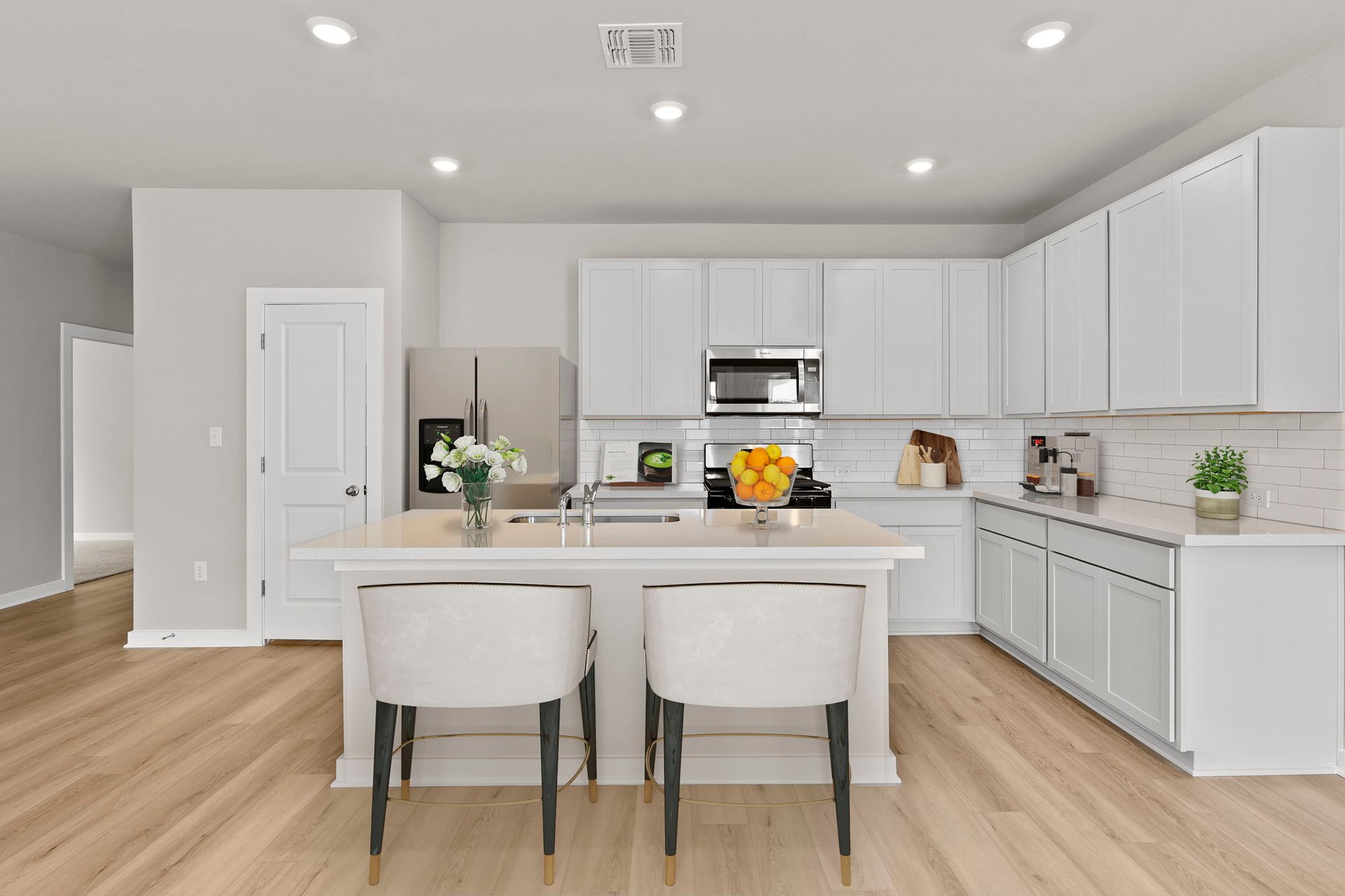13621 Gray Landing Drive Elgin, TX 78621 - Photo 5 of 36 a kitchen with white cabinets and white appliances
