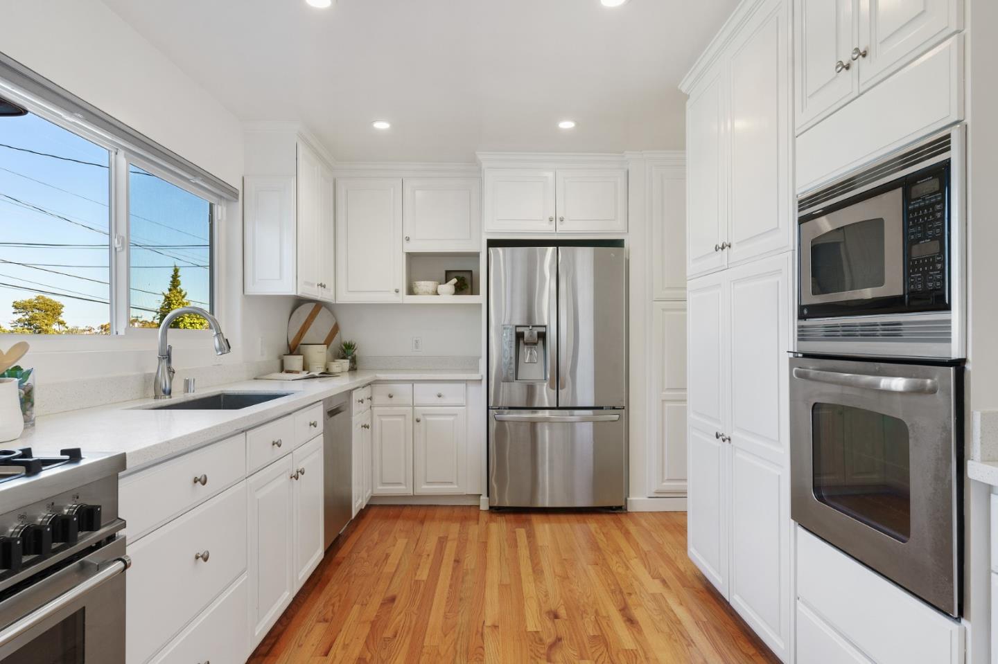 1150 Elmwood Drive Millbrae, CA 94030 - Photo 18 of 46 a kitchen with a refrigerator stove and sink