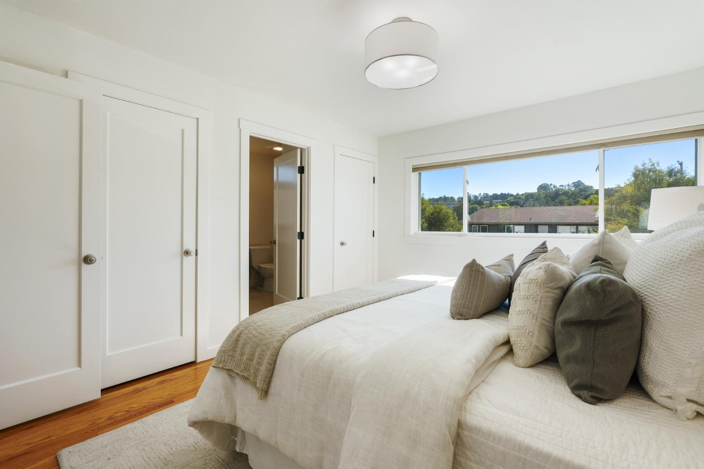 1150 Elmwood Drive Millbrae, CA 94030 - Photo 24 of 46 a bedroom with a bed and a large window