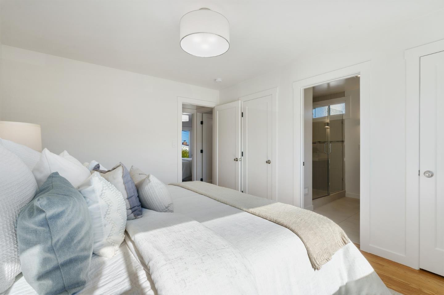 1150 Elmwood Drive Millbrae, CA 94030 - Photo 25 of 46 a bedroom with a bed and a chandelier