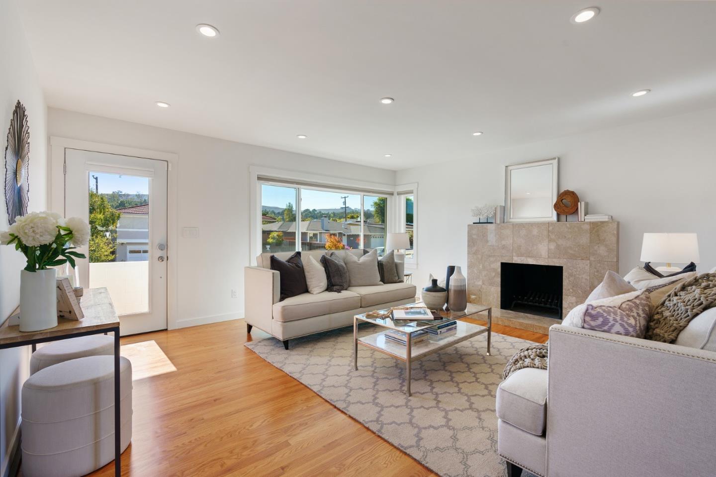 1150 Elmwood Drive Millbrae, CA 94030 - Photo 7 of 46 a living room with furniture a fireplace and a potted plant