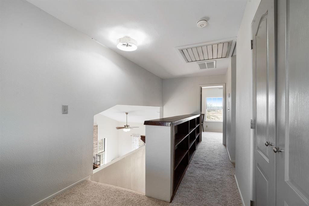 374 County Road Paris, TX 75462 - Photo 16 of 38 a kitchen with a refrigerator and white cabinets